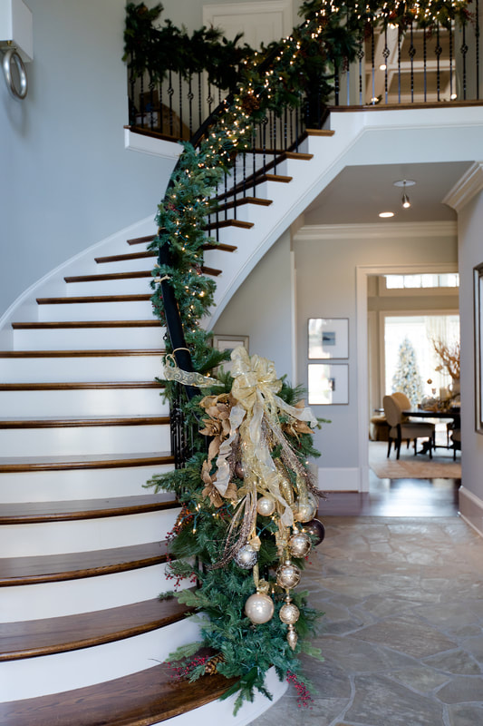 Foyer staircase decorated for Christmas.