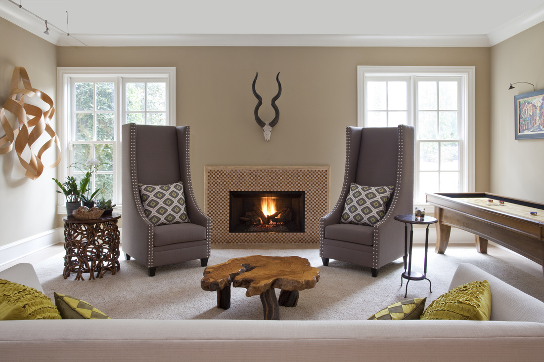 Lower level inspired family room with gas fireplace designed by Robin LaMonte
