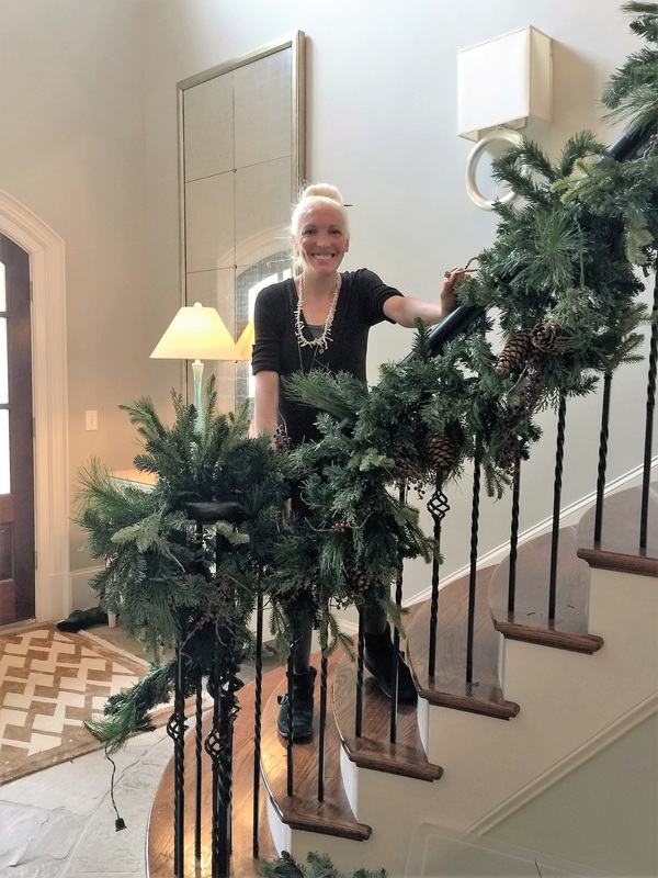 getting the Christmas garland hung on the staircase