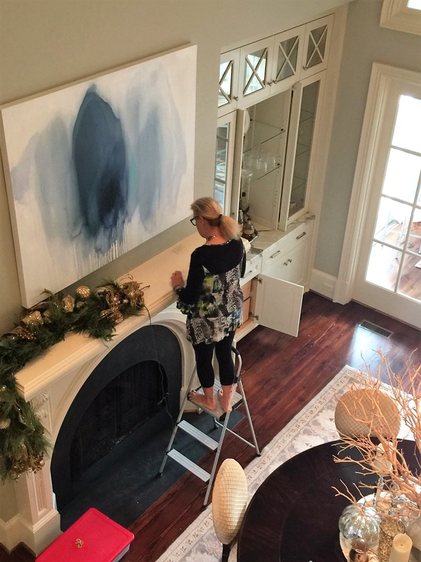Robin LaMonte begins to decorate the fireplace